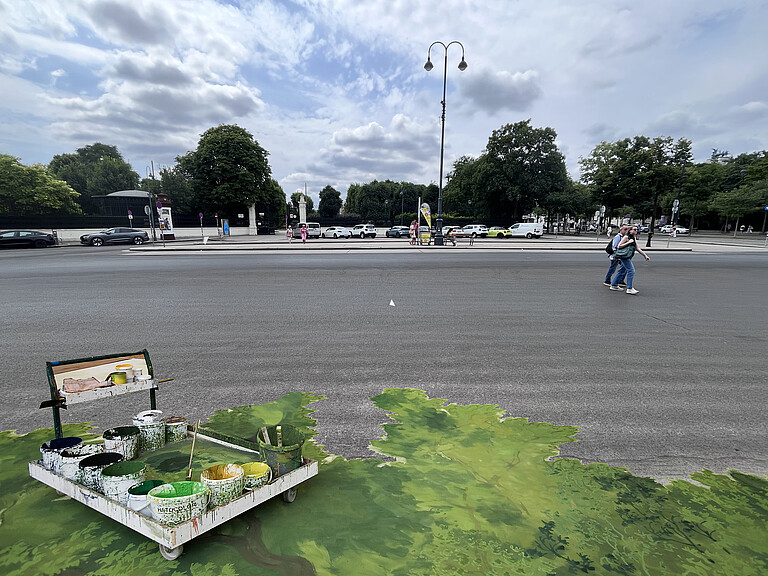Urban space with painted backdrop in the foreground
