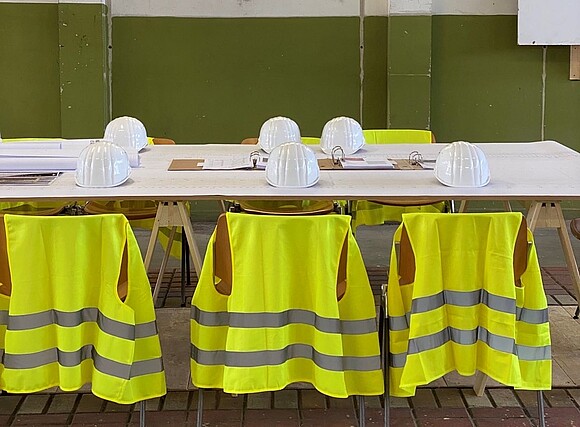 Conference table with helmets and safety vests