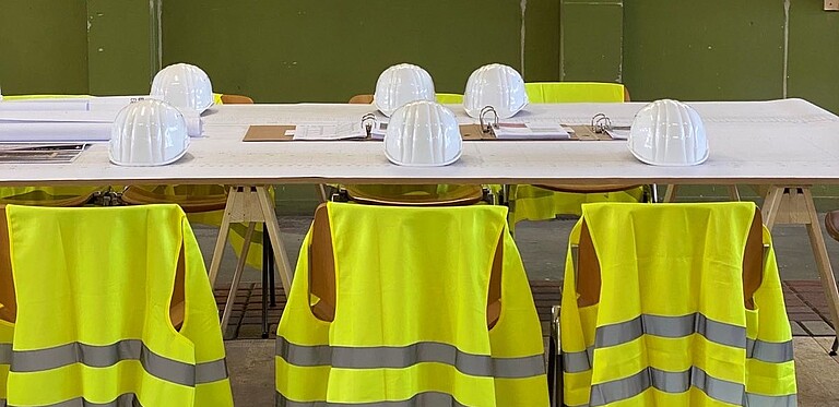 Conference table with helmets and safety vests