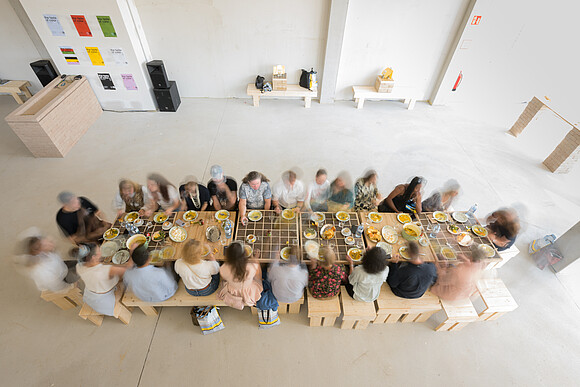 Many people sit at the table and eat