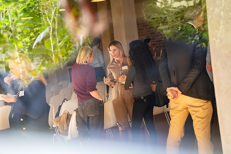 three women talking and networking