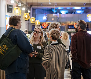 people networking at an event in the Markterei