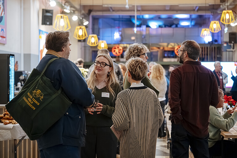 people networking at an event in the Markterei