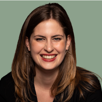 Woman wearing a black blouse in front of a green background