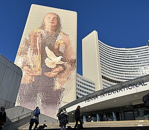 Entrance to the Vienna International Center – UN Vienna. On the building: mural depicting a person a