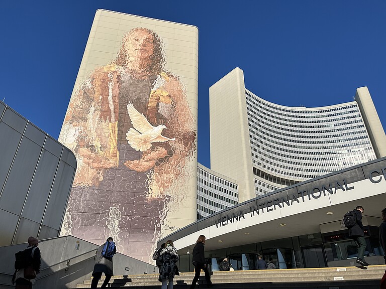 Entrance to the Vienna International Center – UN Vienna. On the building: mural depicting a person a