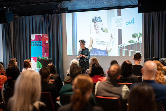 Picture of a speaker with audience in the foreground
