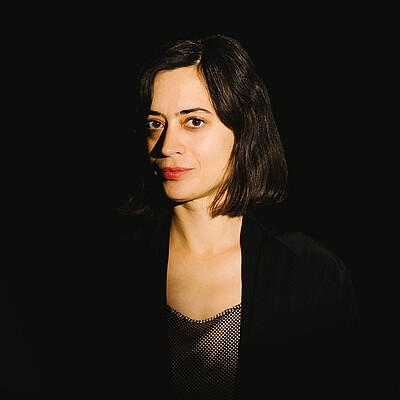 Portrait of a female artist with a black background