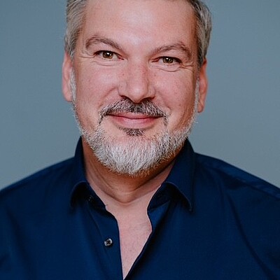 Portrait of man with beard and grey hair