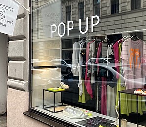 Exterior view of the pop-up store, display with clothing