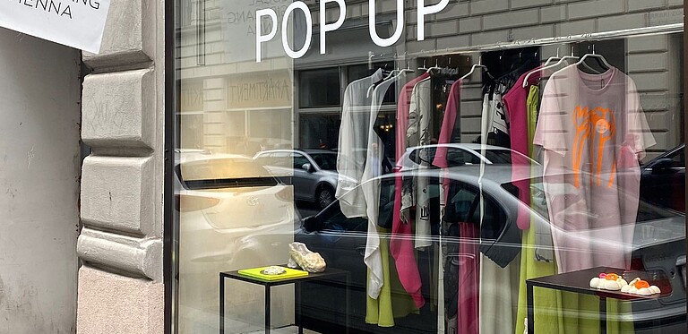 Exterior view of the pop-up store, display with clothing