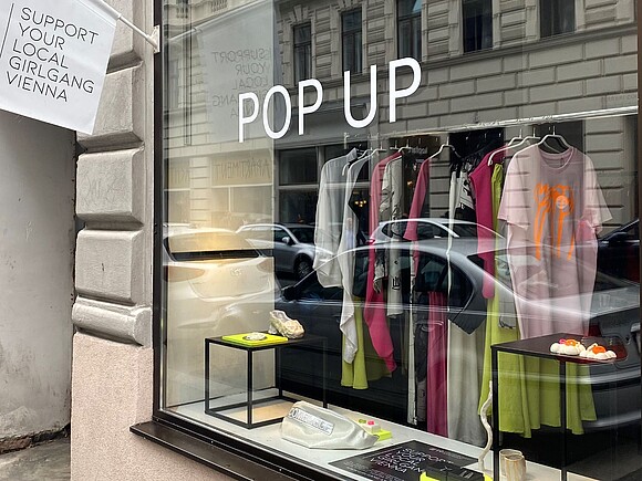 Exterior view of the pop-up store, display with clothing