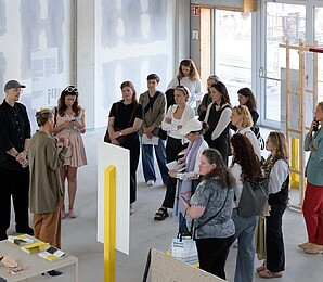 Group of people being guided through an exhibition