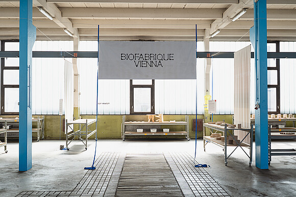Biofabrique Vienna logo displayed on a hanging banner in the Nordwestbahnhof hall