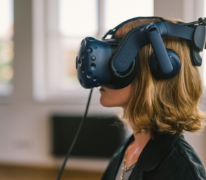 woman with red-blonde hair and VR glasses