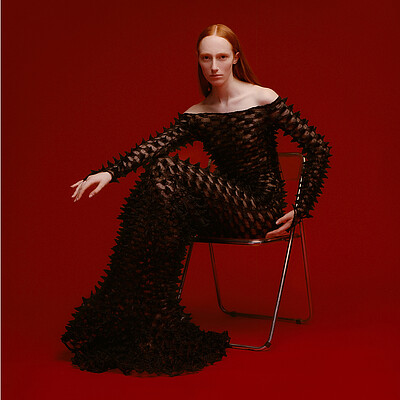 fashion model with black dress in front of red background