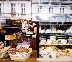 Bread and cheese on display in a grocery shop