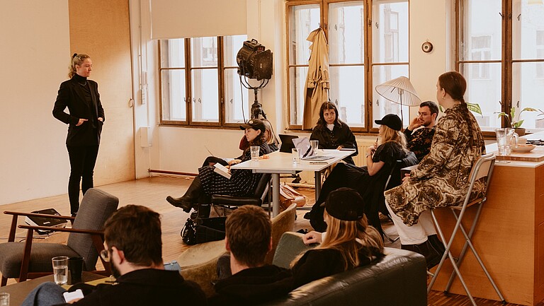 Lecturer and group of seated listeners