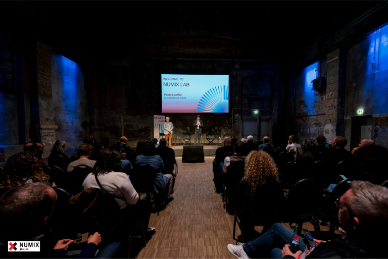 Lecture hall with speakers, audience and Screen "Numix Lab"