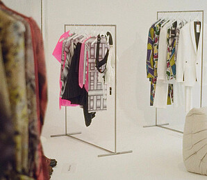 White room with clothes racks and fashion