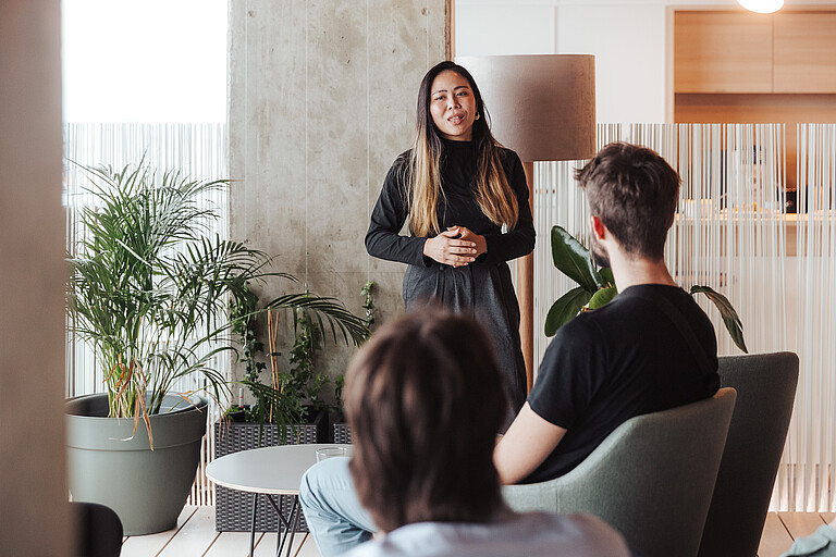 Woman as lecturer in front of small group