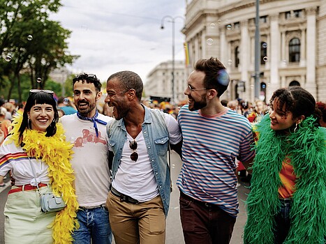 Vienna Pride Parade Expats Group of smiling people standing in front of Vienna's Burgtheater